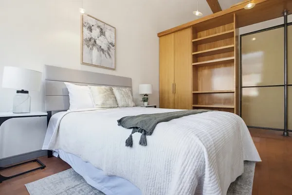 a bedroom with a bed and wall painting