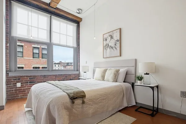 a bed sitting in a bedroom next to a large window