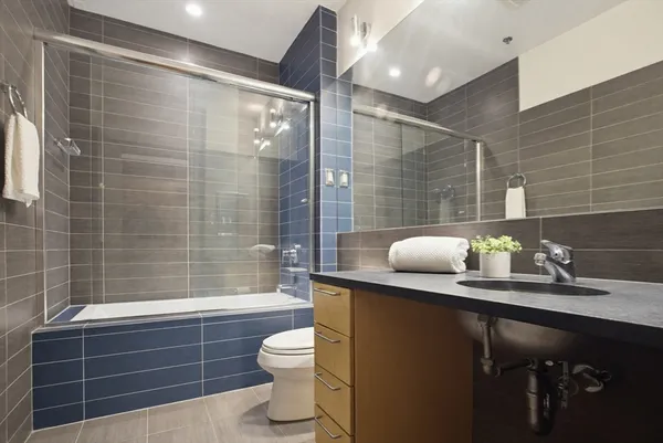 a bathroom with a sink toilet and shower
