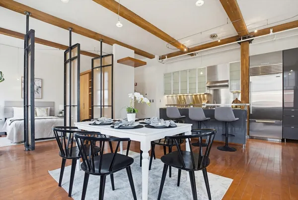 a view of a a dining room with furniture window and wooden floor