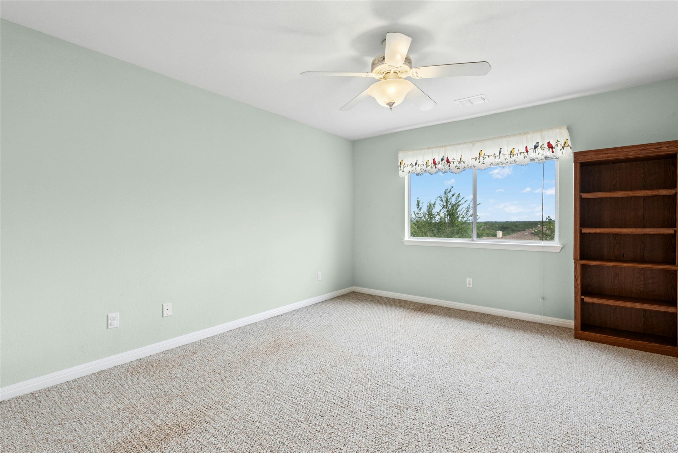 7500 Shadowridge Run, Unit 34 Austin, TX 78749 - Photo 25 of 27 an empty room with windows and fan