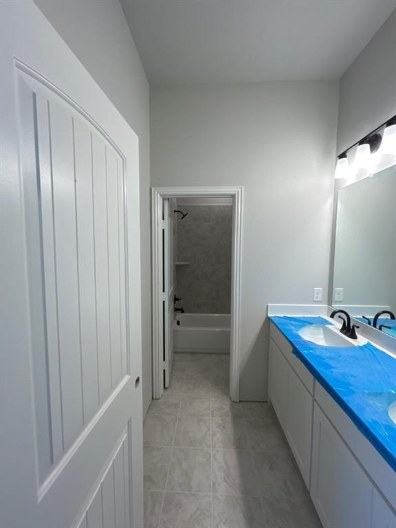 8935 County Road 623 Blue Ridge, TX 75424 - Photo 14 of 17 Modern bathroom featuring a dual vanity with white cabinetry, under-mount sinks, and matte black faucets