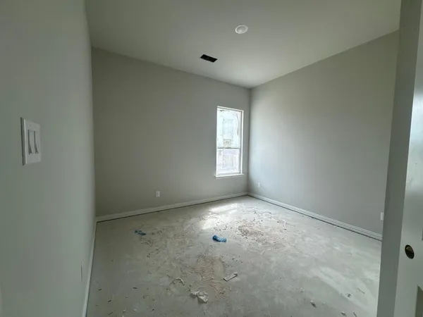 an empty room with windows and closet