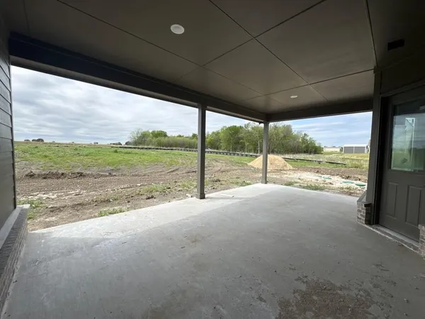 a view of a big room with floor to ceiling windows and garden