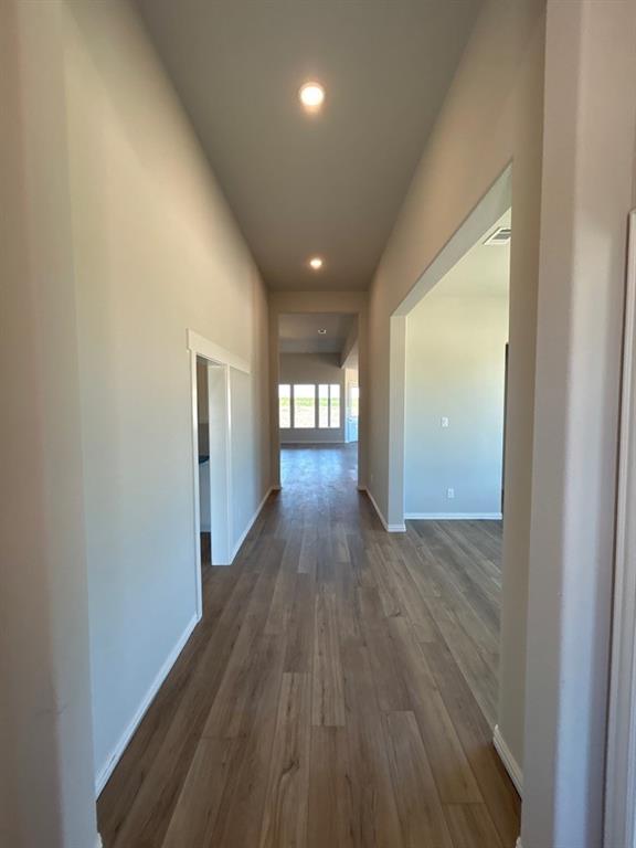 8935 County Road 623 Blue Ridge, TX 75424 - Photo 3 of 17 Long hallway with recessed lighting and wood-finish flooring extending into distant rooms