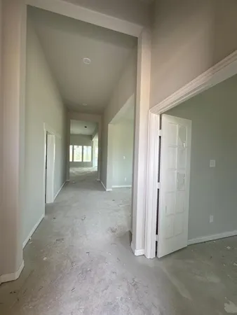 an empty room with windows and entrance