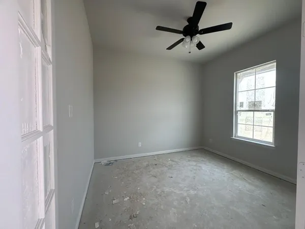 a view of room with a ceiling fan and window