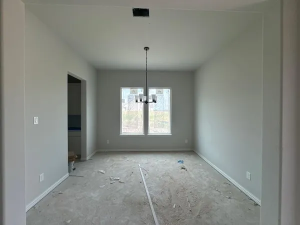 en empty room with windows and fan