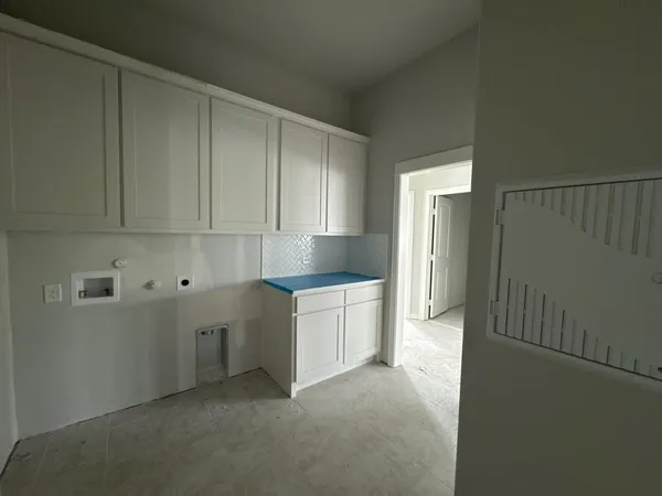 a kitchen with white cabinets