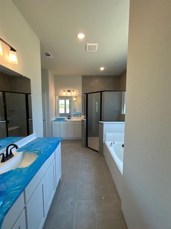 8935 County Road 623 Blue Ridge, TX 75424 - Photo 10 of 17 Bathroom featuring dual vanities with white cabinetry, a built-in soaking tub, and a separate glass-enclosed shower