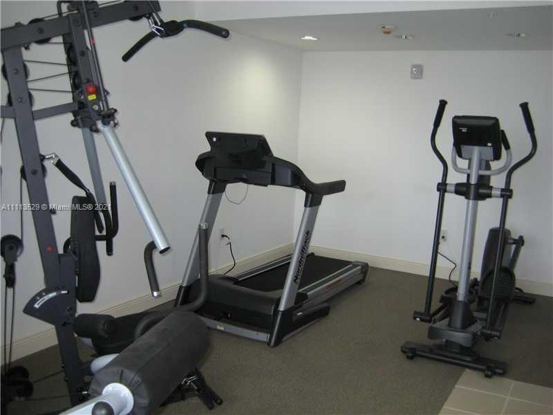 2701 Southwest 3rd Avenue, Unit 705 Miami, FL 33129 - Photo 2 of 10 a room with gym equipment and windows