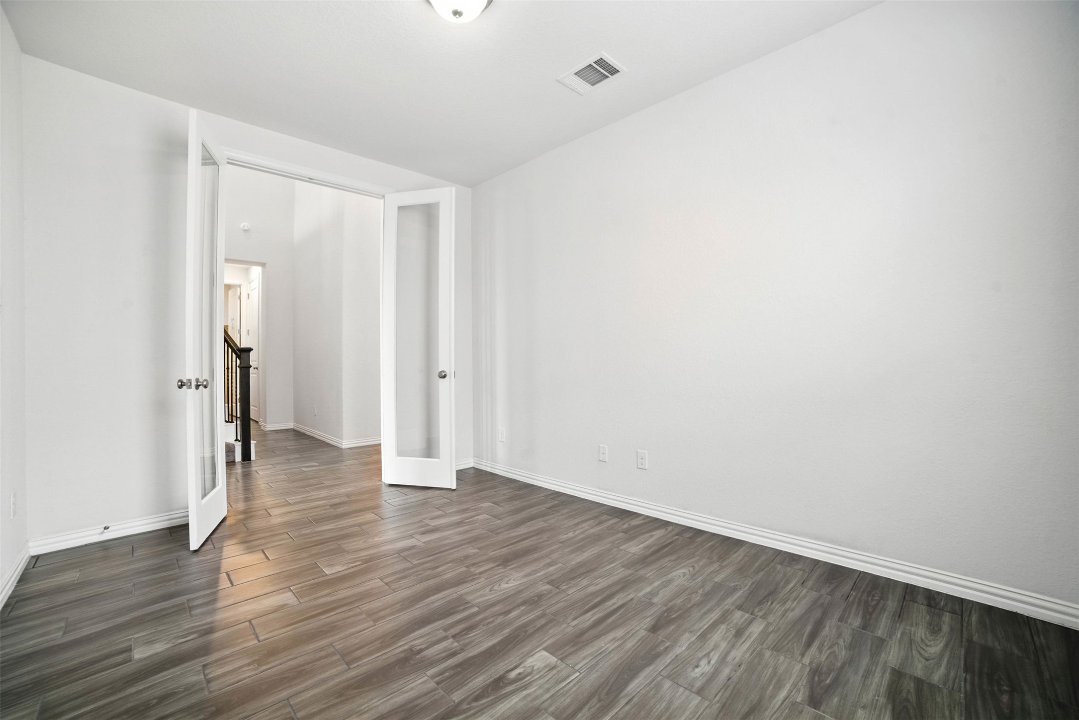 3054 Columbus Loop Round Rock, TX 78665 - Photo 14 of 40 Unfurnished bedroom with dark wood-type flooring and french doors