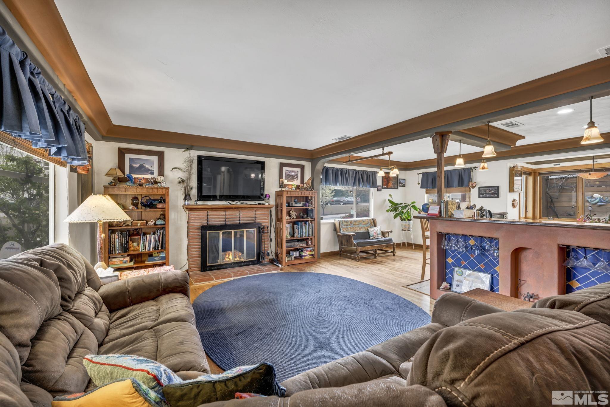1925 Elmcrest Drive Reno, NV 89503 - Photo 21 of 32 a living room with fireplace furniture and a flat screen tv