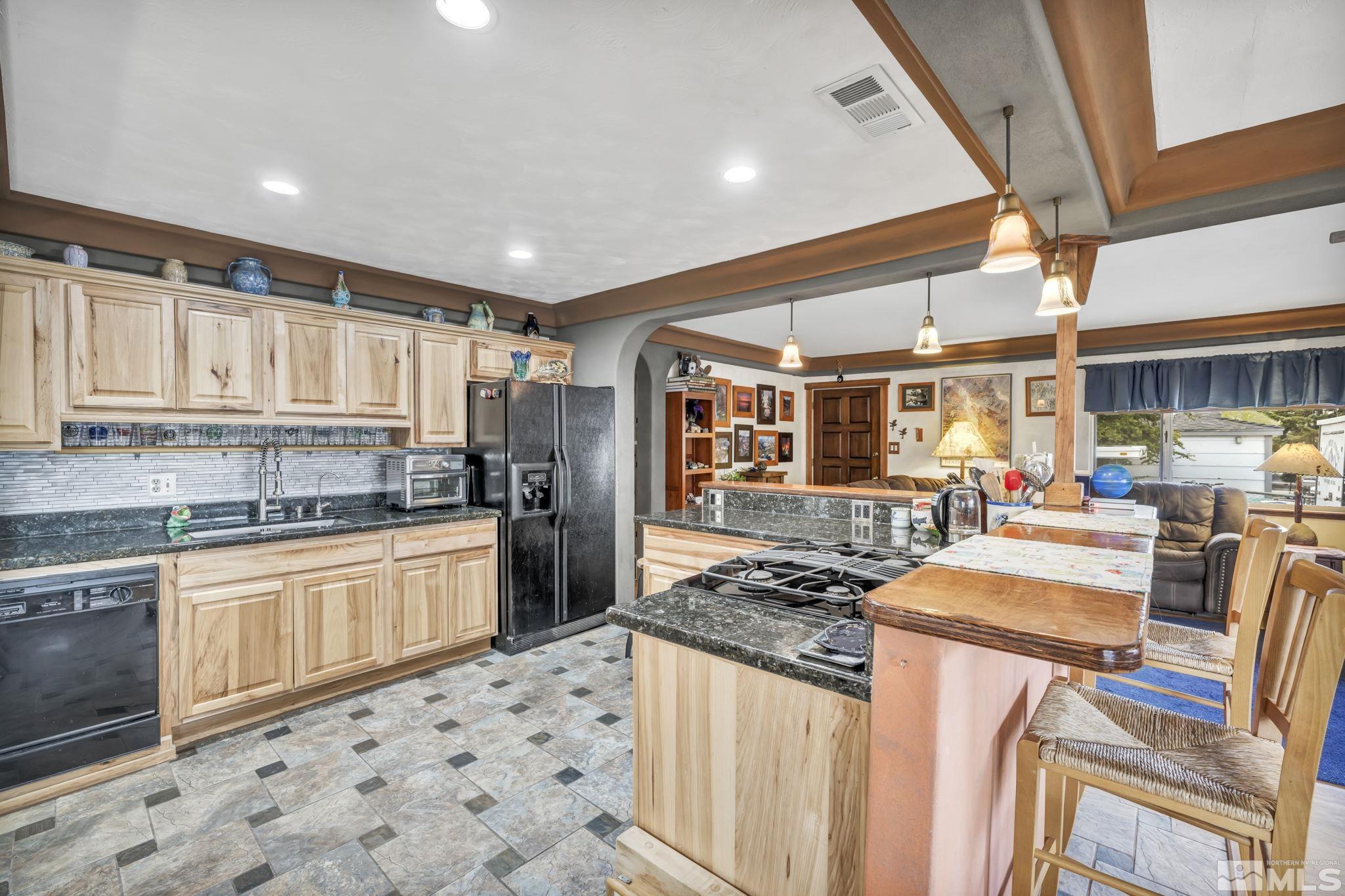 1925 Elmcrest Drive Reno, NV 89503 - Photo 27 of 32 a kitchen with stainless steel appliances granite countertop a sink and cabinets