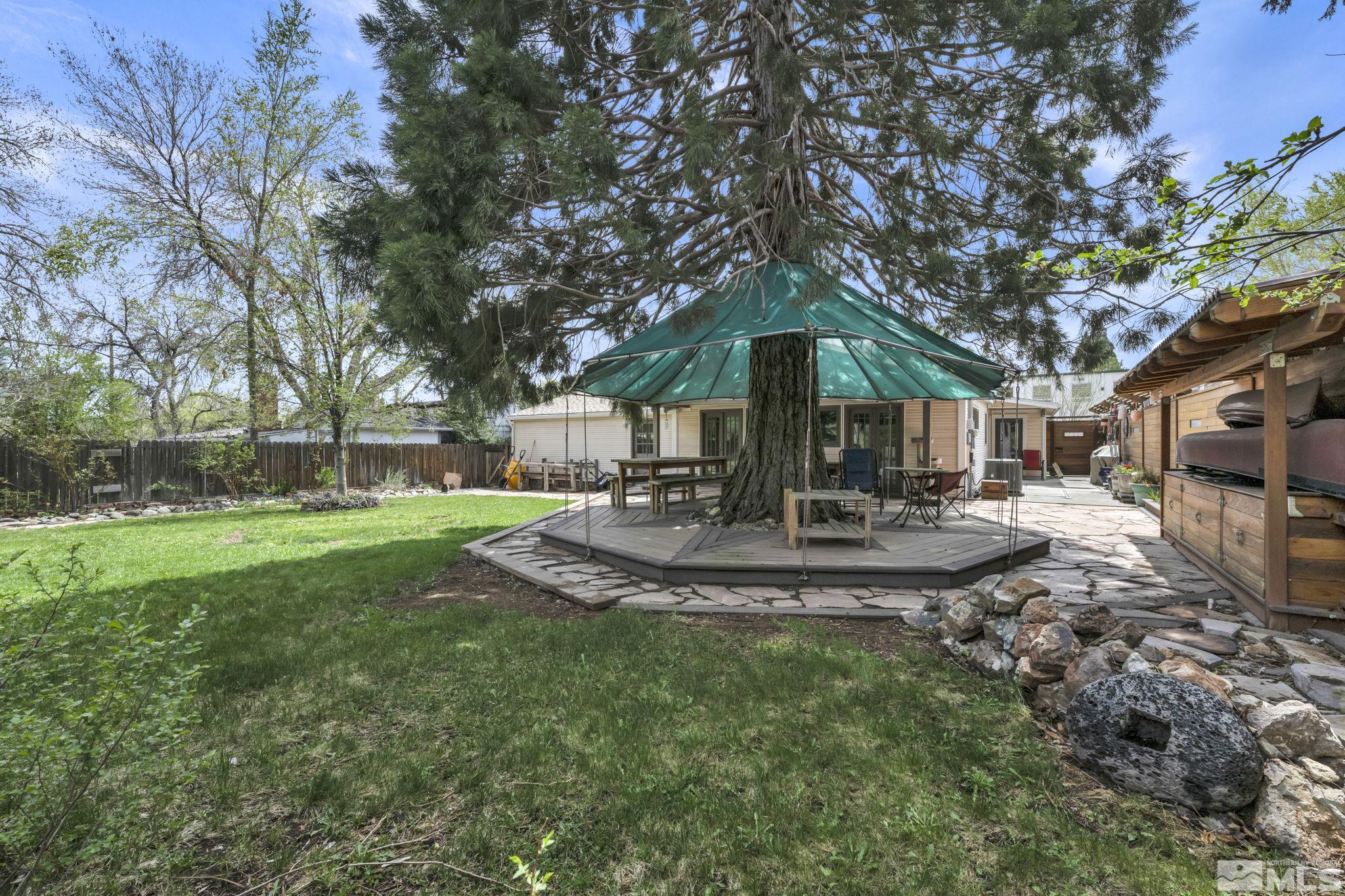 1925 Elmcrest Drive Reno, NV 89503 - Photo 8 of 32 a view of a yard with a fountain and large trees
