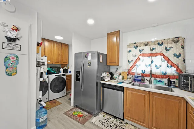 a view of a kitchen with a refrigerator and washer