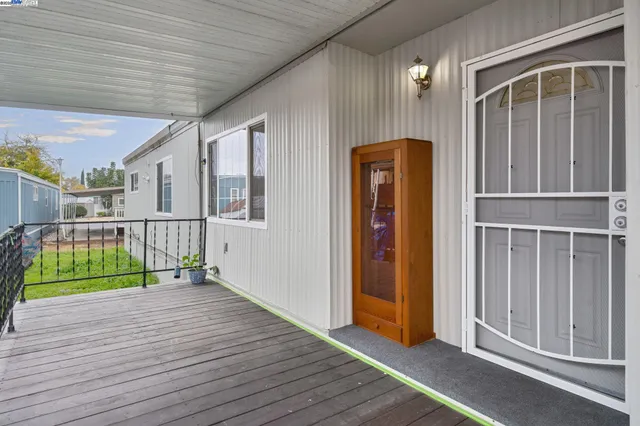 a kitchen with stainless steel appliances granite countertop a stove a refrigerator and a sink with wooden cabinets