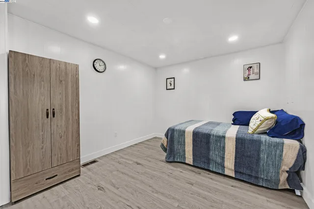 a living room with a bed and a walk in closet