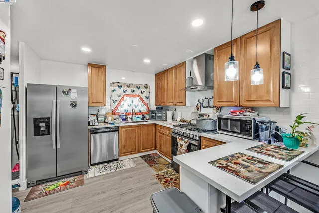 a kitchen with stainless steel appliances granite countertop a refrigerator stove microwave and sink
