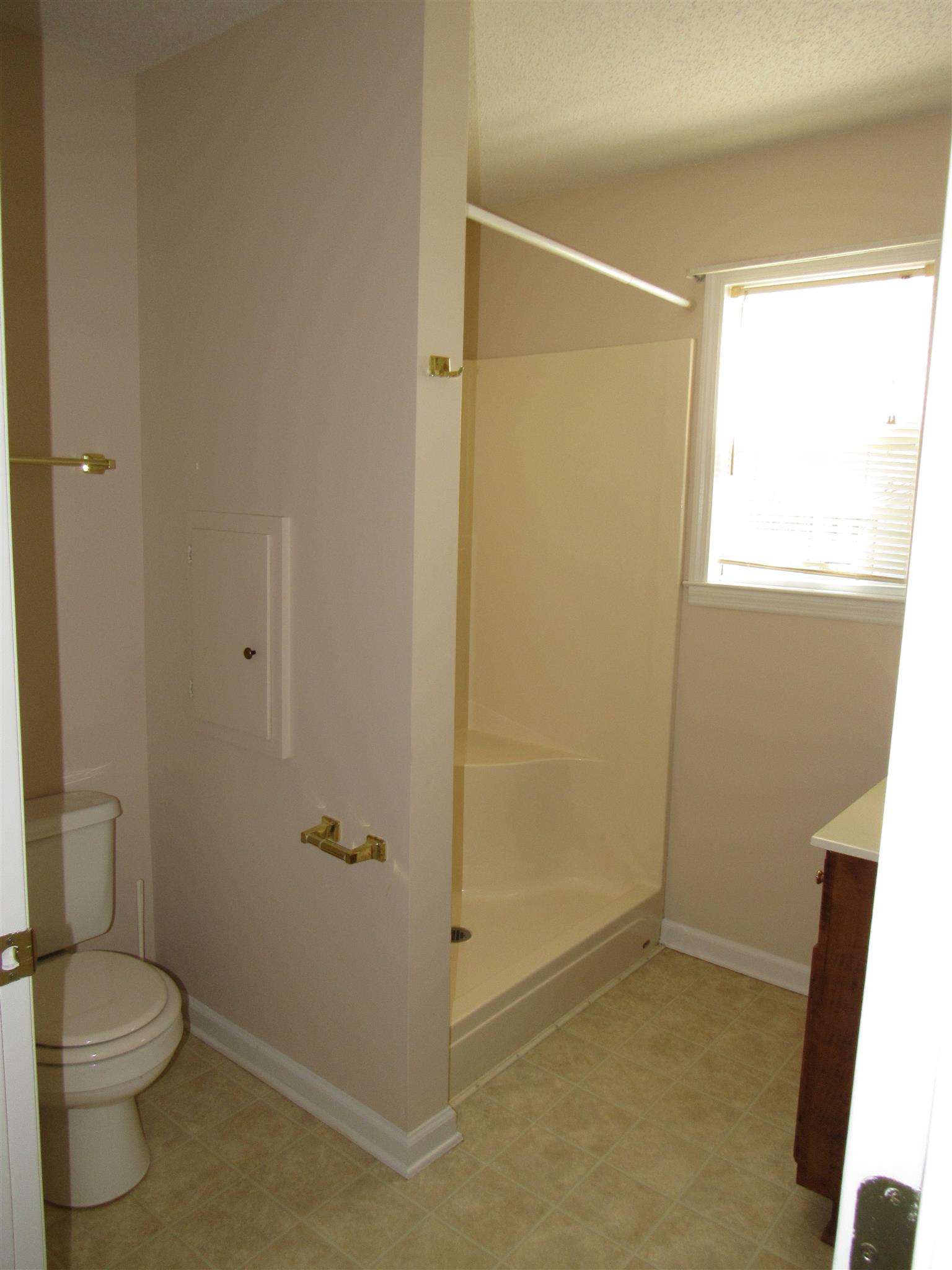 275 Jones Road Taft, TN 38488 - Photo 12 of 26 a bathroom with a granite countertop sink a toilet and shower
