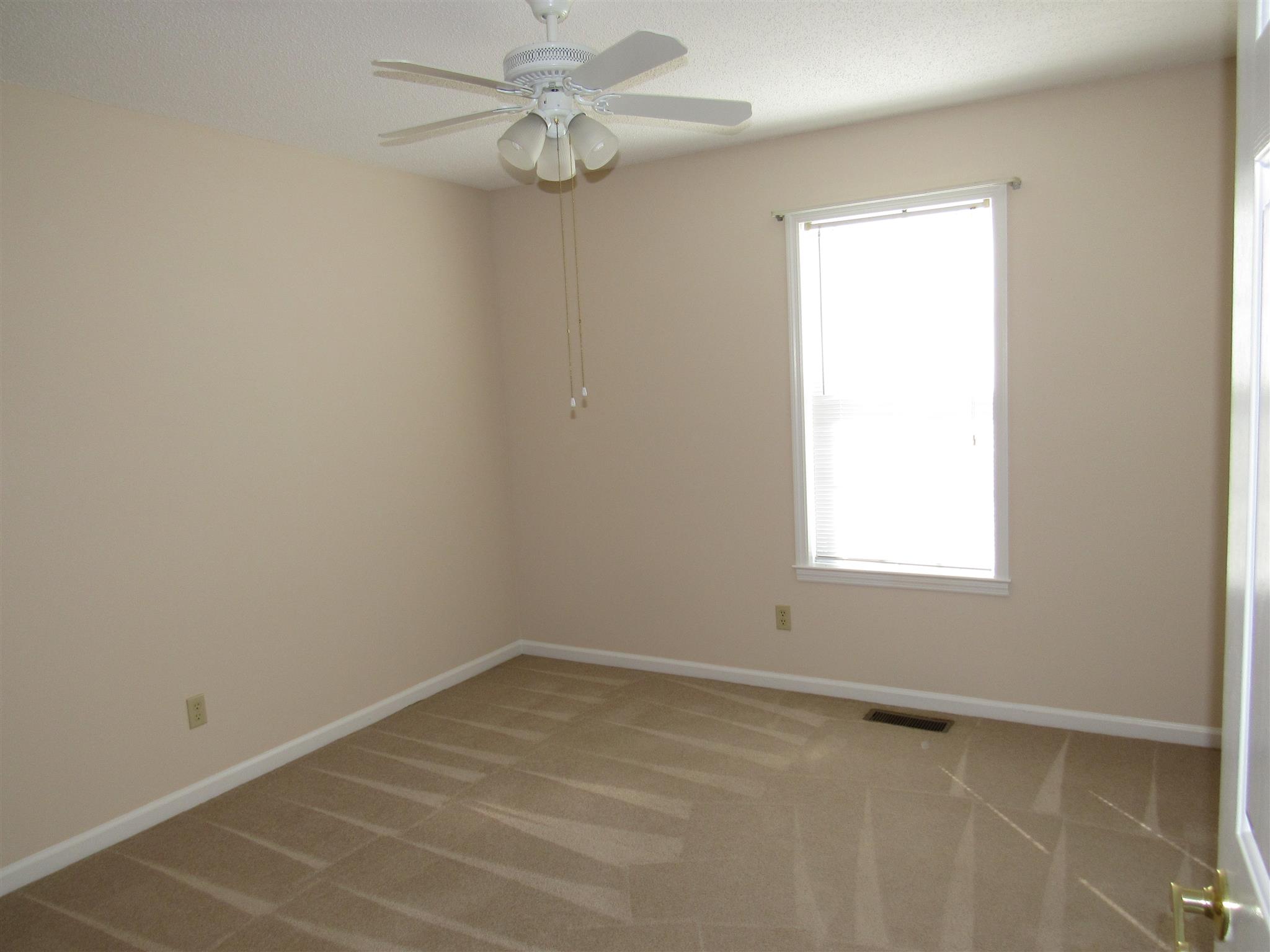 275 Jones Road Taft, TN 38488 - Photo 13 of 26 an empty room with a window and a fan