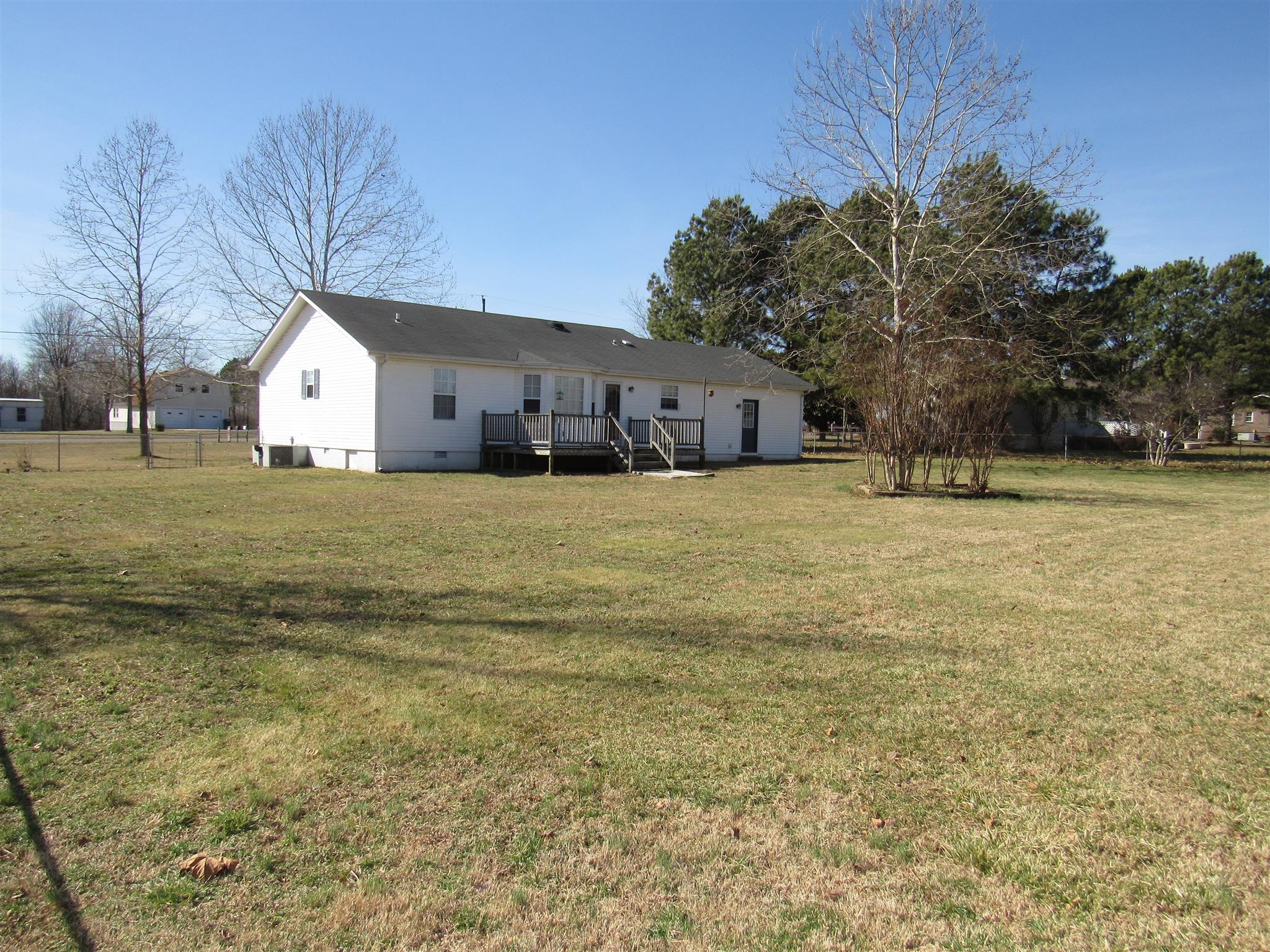 275 Jones Road Taft, TN 38488 - Photo 23 of 26 a large house with a big yard and large trees