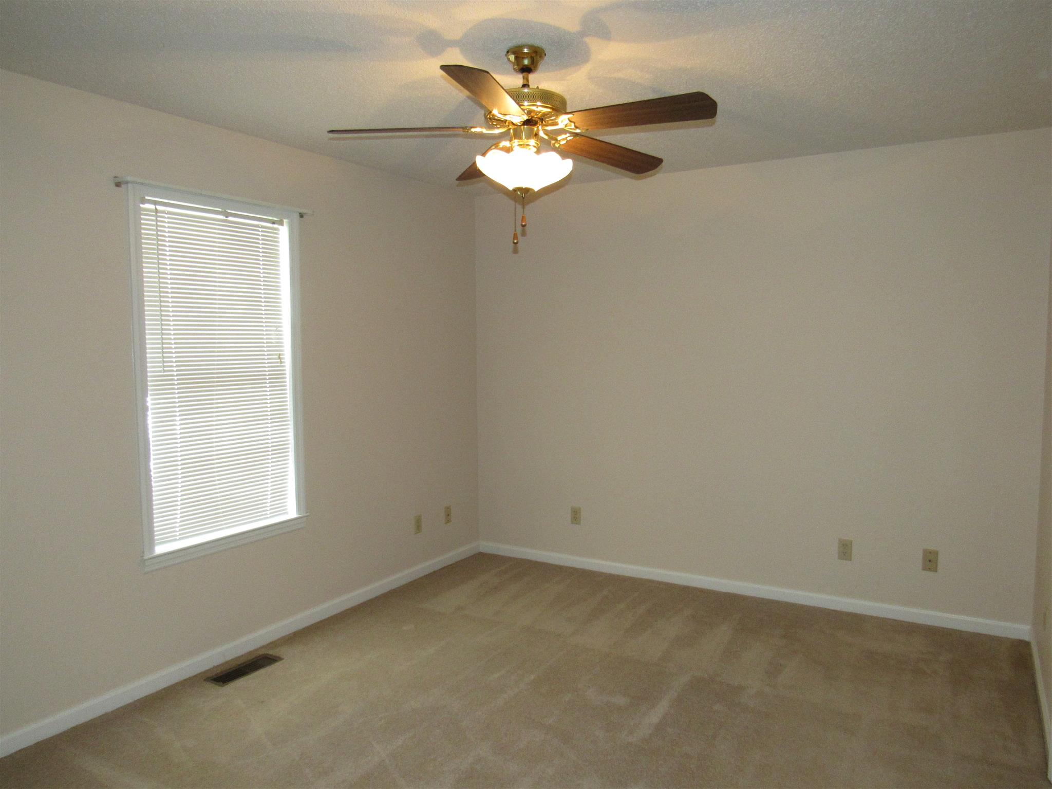 275 Jones Road Taft, TN 38488 - Photo 4 of 26 an empty room with a window and a fan