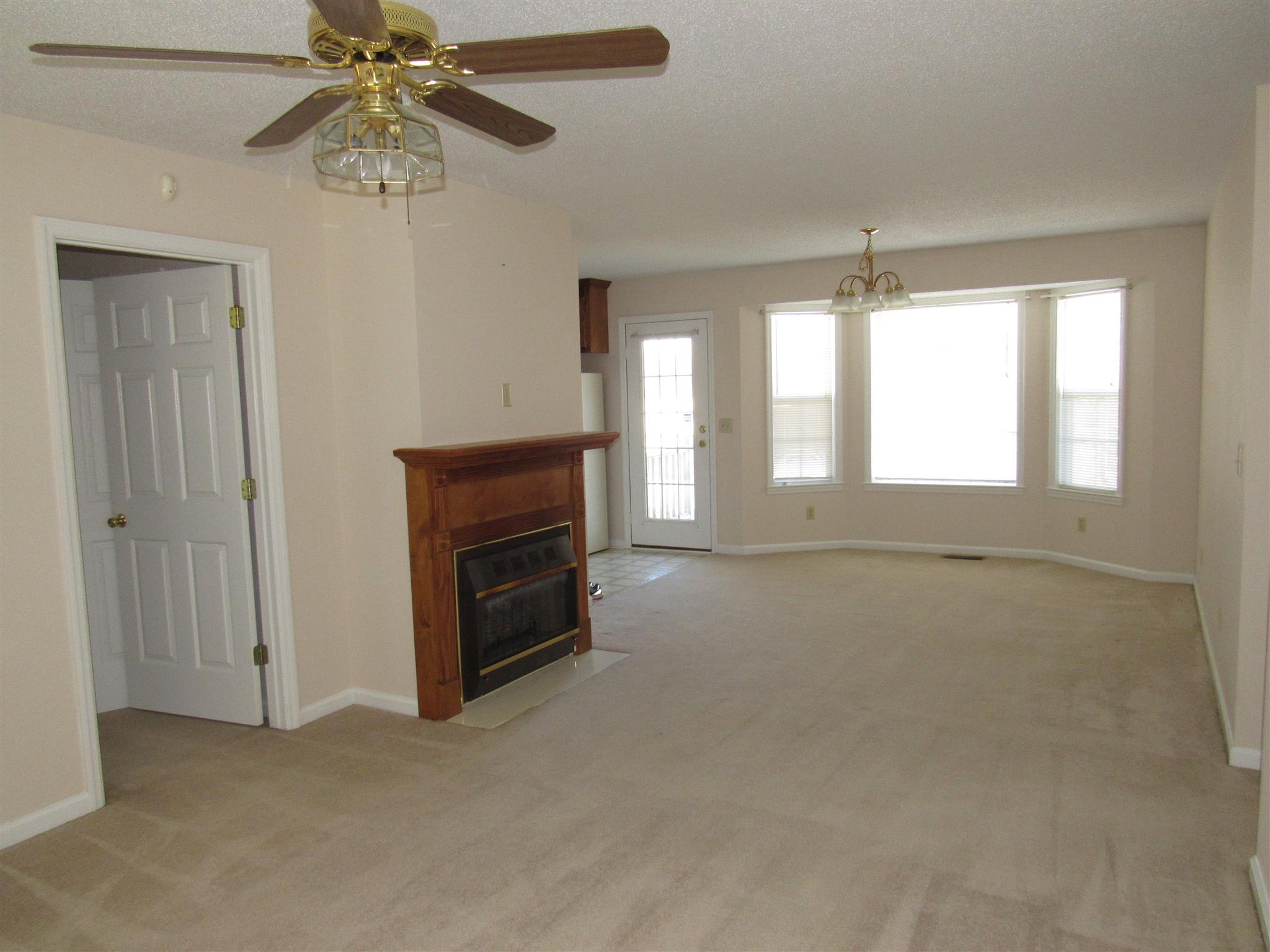 275 Jones Road Taft, TN 38488 - Photo 9 of 26 an empty room with chandelier fan and windows