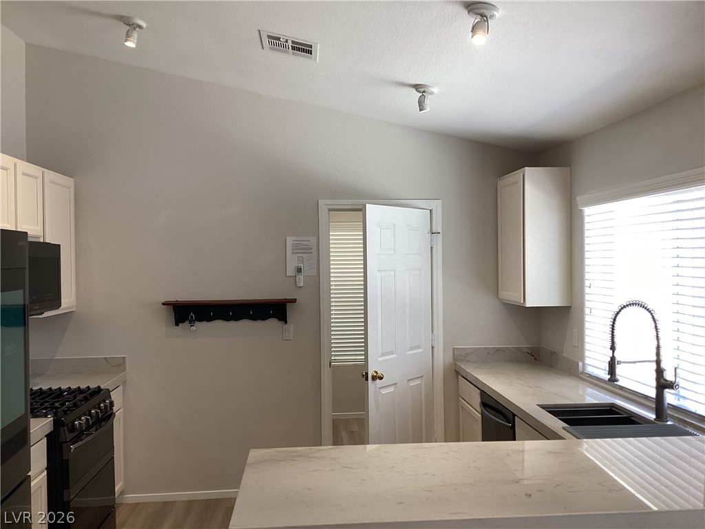 2135 Hidden Ranch Terrace Henderson, NV 89052 - Photo 5 of 27 Culinary adventures await in this kitchen featuring abundant counter space and modern appliances.