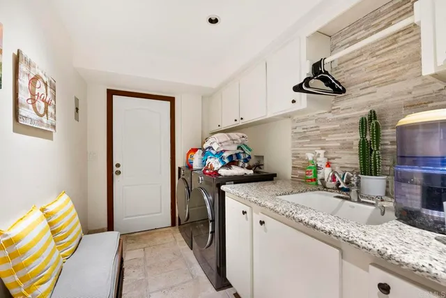 a bedroom with a bed and large windows