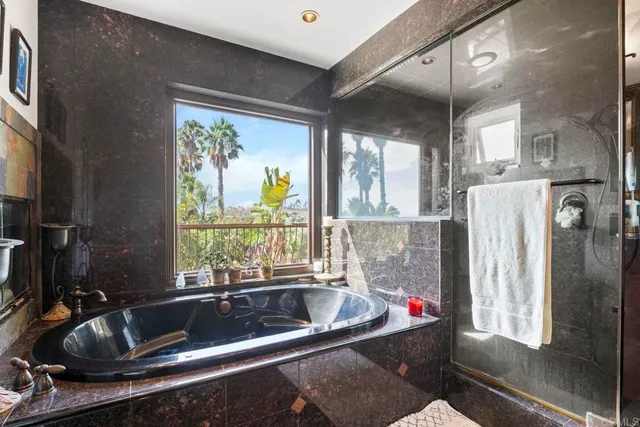 a bathroom with a sink a toilet and painting on the wall