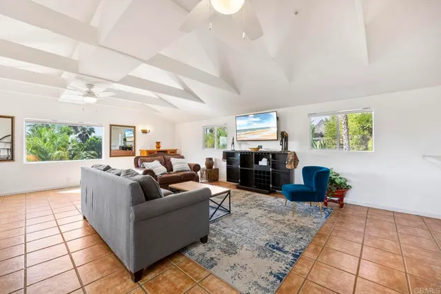 an aerial view of a house with a yard and lake view