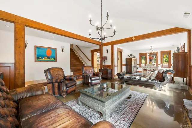 a living room with fireplace furniture and a rug