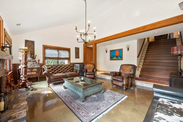 a view of a dining room with furniture wooden floor and chandelier