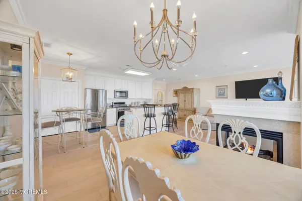 a kitchen with stainless steel appliances kitchen island granite countertop a table and chairs in it