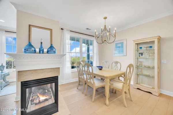 a dining room with furniture a fireplace and a chandelier