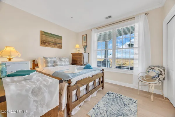 a spacious bedroom with a bed and a window