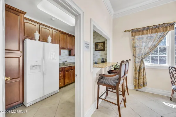 a view of kitchen with furniture and refrigerator