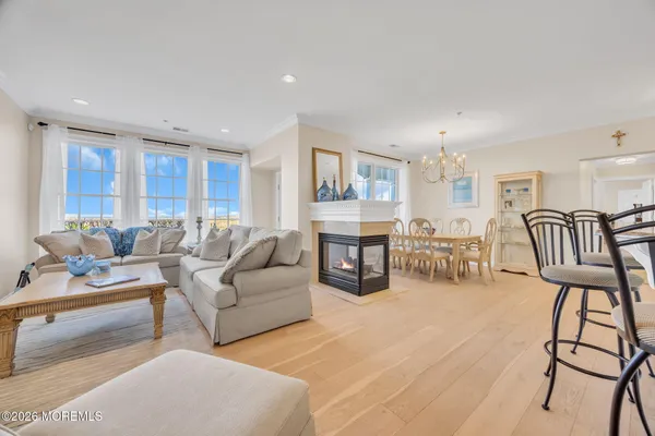 a living room with furniture and a dining table with kitchen view