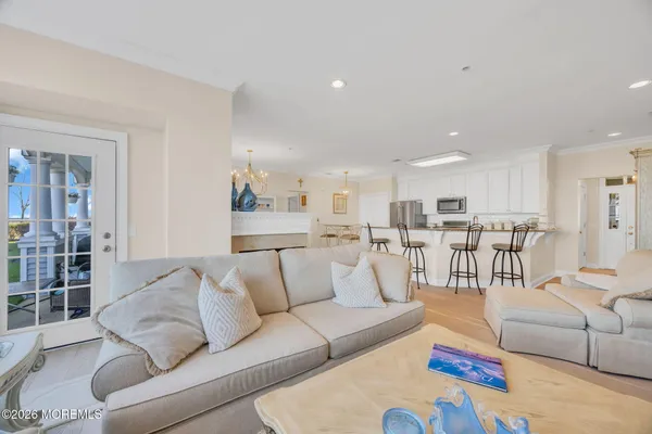 a living room with furniture and view of kitchen