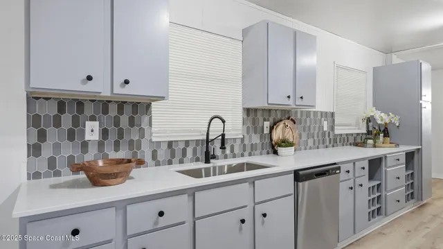 a kitchen with a sink and cabinets