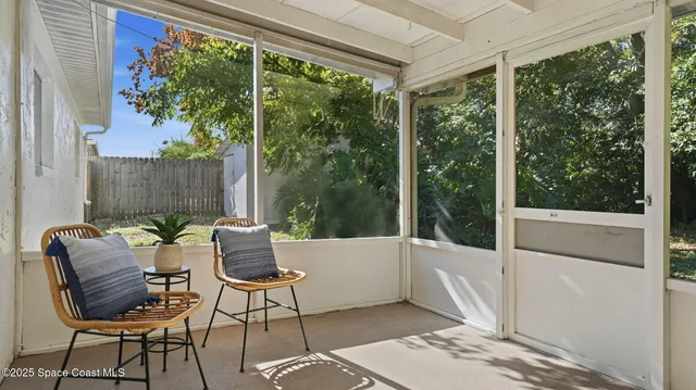 a balcony with furniture and a potted plant