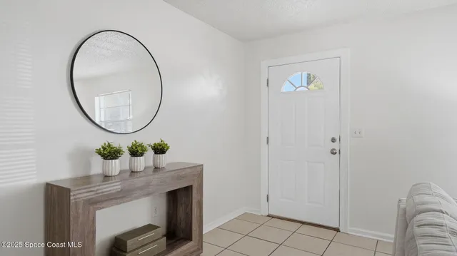 a room with a table and flowerpot