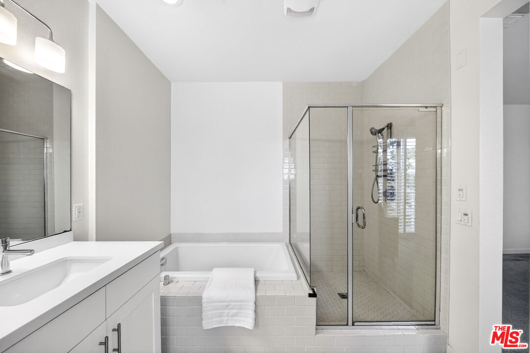 676 Colorado Circle Carson, CA 90745 - Photo 21 of 36 a bathroom with a granite countertop sink mirror and shower