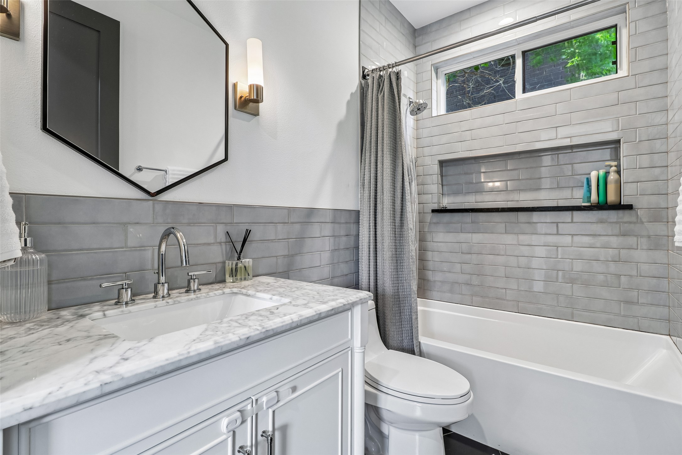 1706 Perez Street, Unit 1 Austin, TX 78721 - Photo 19 of 36 A well-appointed bathroom offers clean lines with a marble-topped vanity and tiled bath.