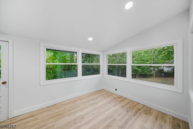 330 Springbrook Trail Sparta, NJ 07871 - Photo 11 of 41 a view of an empty room with a window and wooden floor