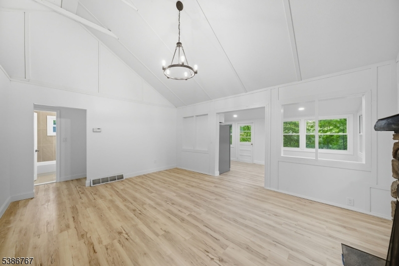 330 Springbrook Trail Sparta, NJ 07871 - Photo 4 of 41 a view of an empty room with a window and wooden floor