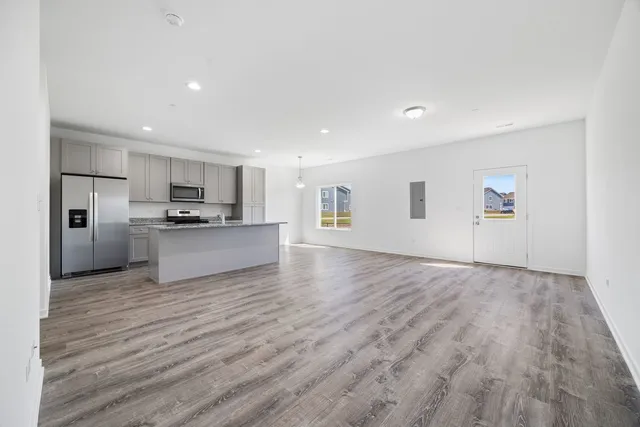a view of a kitchen with a sink and a refrigerator