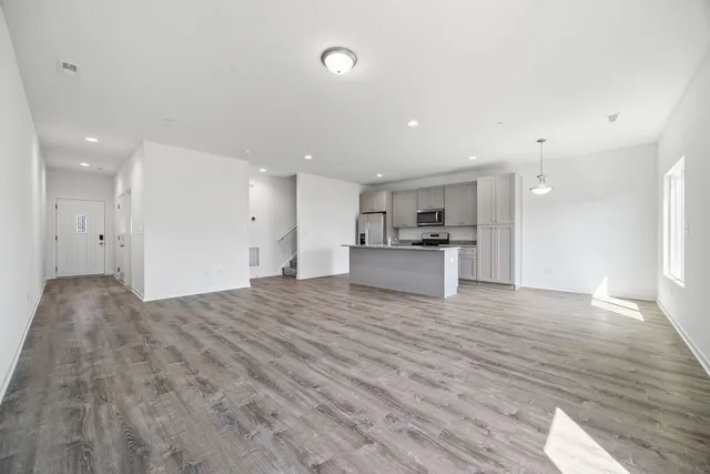 a view of a kitchen with a sink and a refrigerator