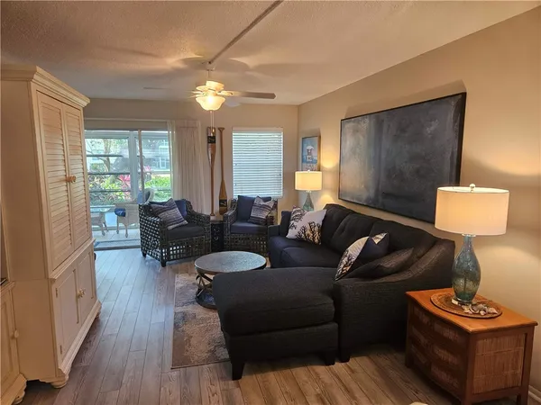 a living room with furniture and a lamp